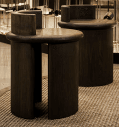 A dark-stained wooden stool featuring a round seat and a low, curved backrest, supported by a monoli… — 3D model