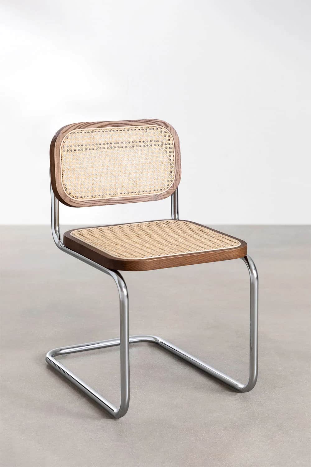 A modern cantilever dining chair featuring a tubular chrome frame, a dark-stained wood and cane webb… — 3D model