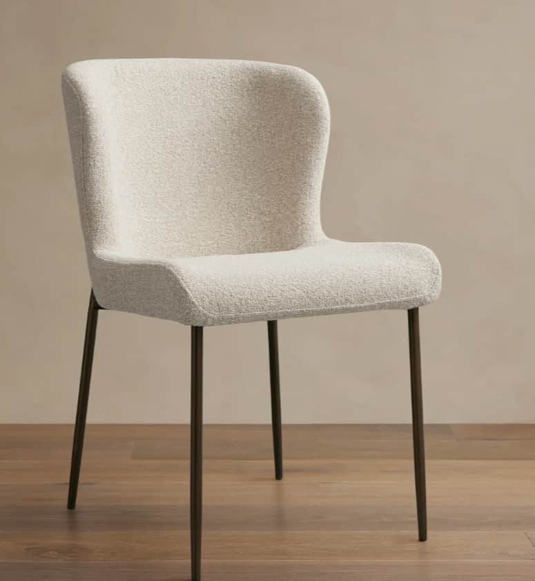An armless dining chair featuring a gently curved, high backrest and seat, fully upholstered in a te… — 3D model