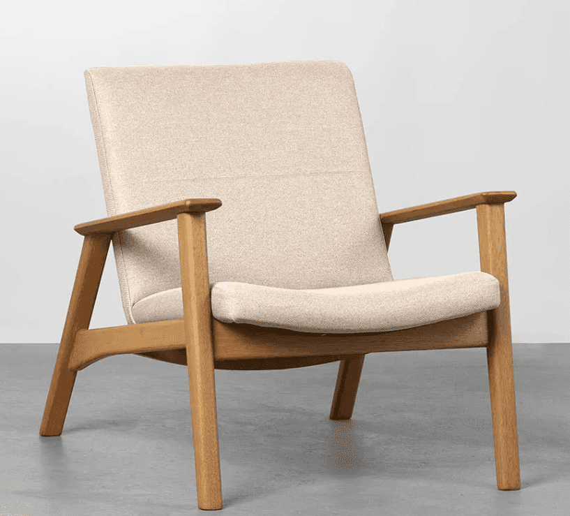 A modern armchair with a light-colored upholstered seat, back, and armrests, supported by a wooden f… — 3D model
