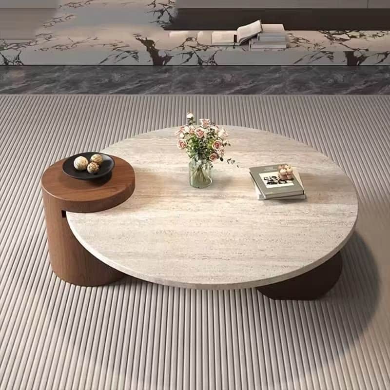 A modern coffee table featuring a large circular travertine top supported by dark wood cylindrical b… — 3D model