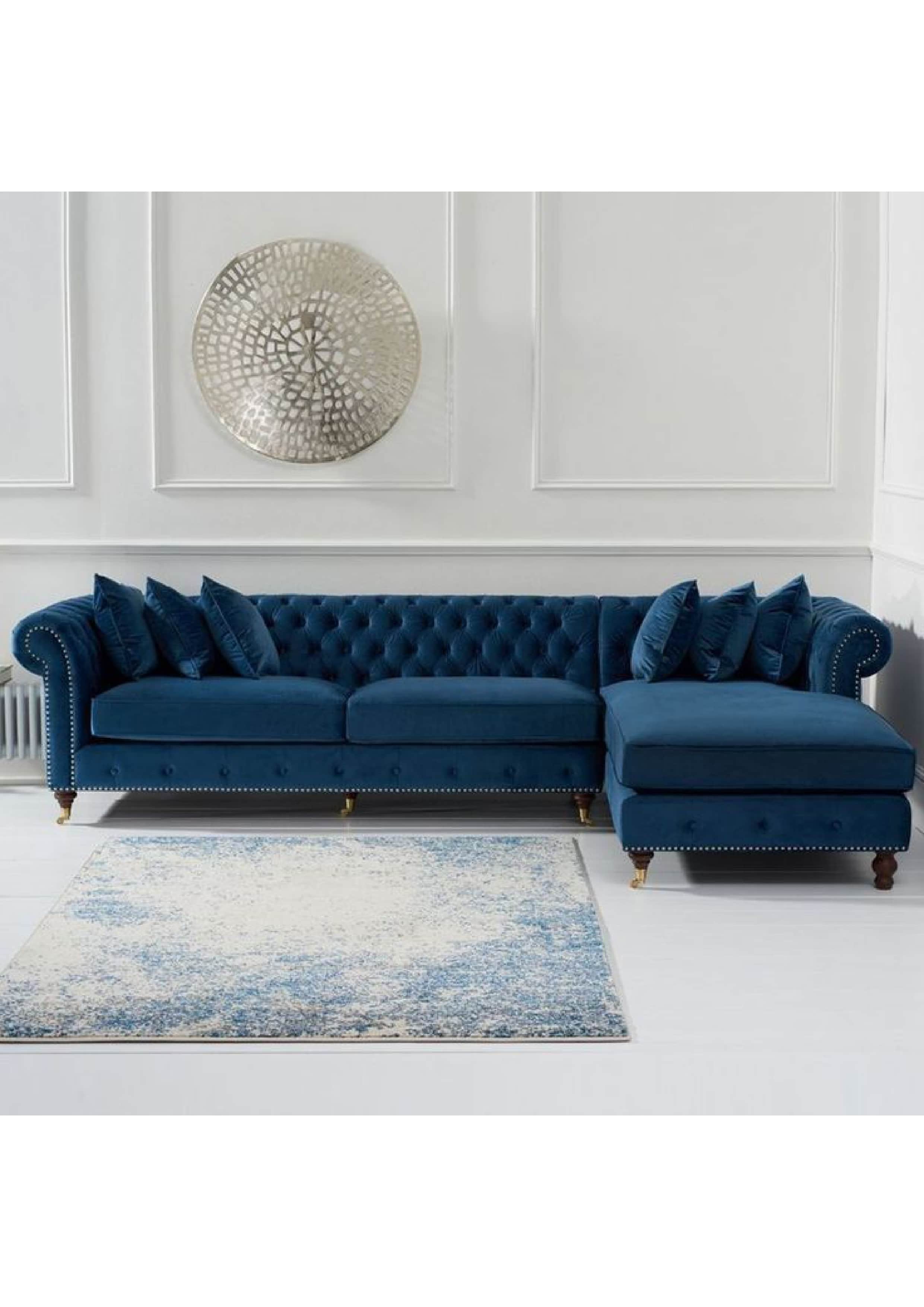 A luxurious blue velvet Chesterfield-style sectional sofa with a right-hand facing chaise lounge. It… — 3D model
