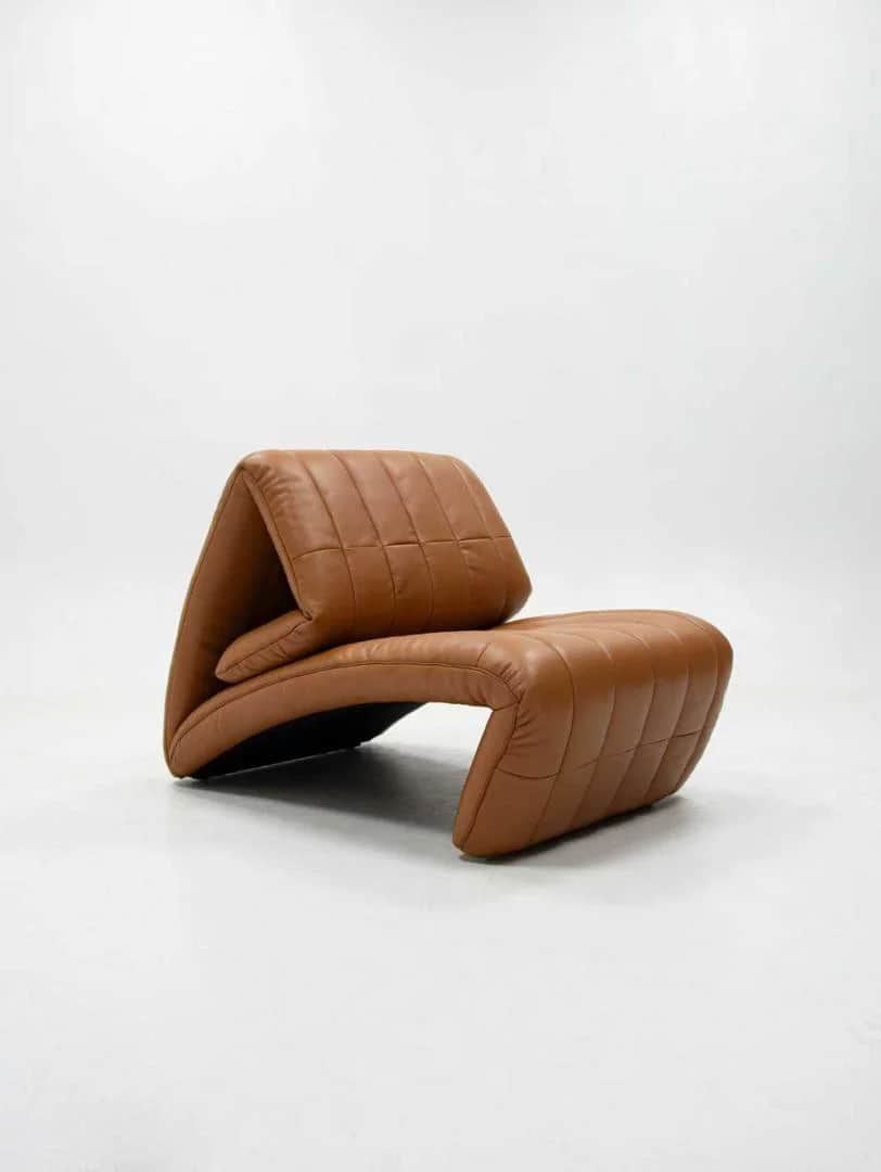 A unique contemporary lounge chair featuring a distinctive folded form upholstered in quilted brown… — free OBJ 3D model