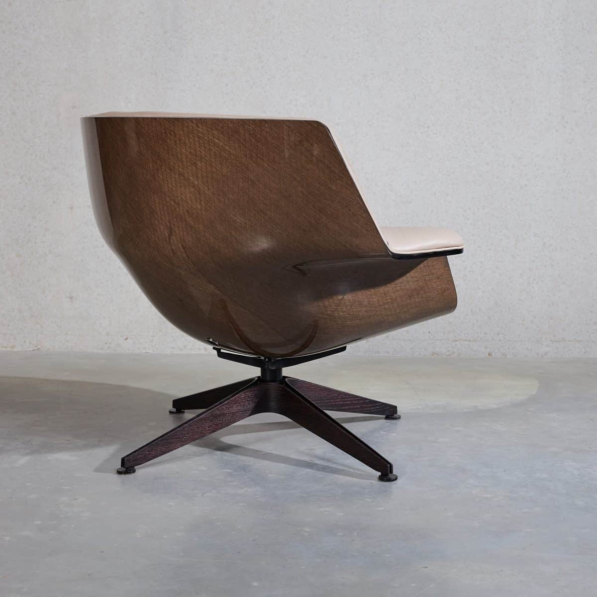 A modern lounge chair featuring a continuous, curved shell made from dark-stained molded plywood. Th… — free OBJ 3D model