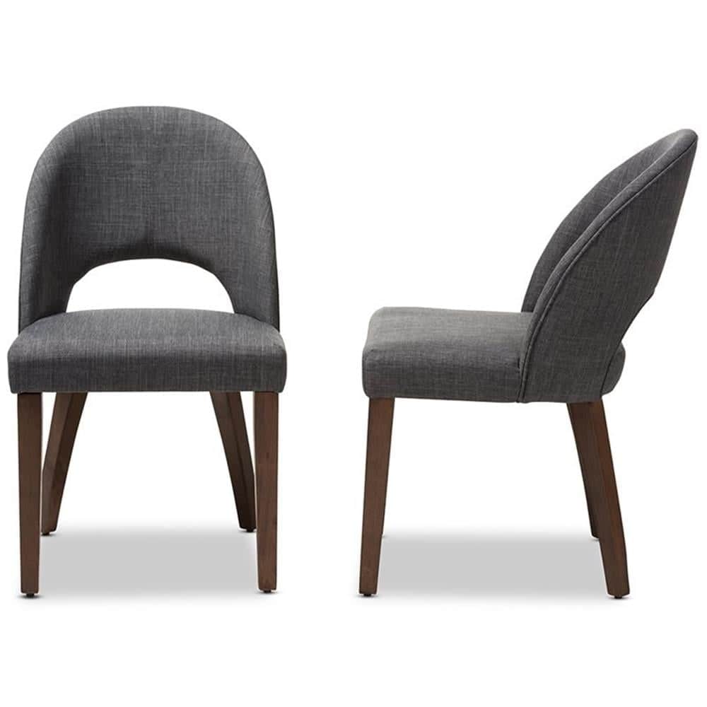 A contemporary dining chair upholstered in dark gray fabric, featuring a curved backrest with a dist… — 3D model