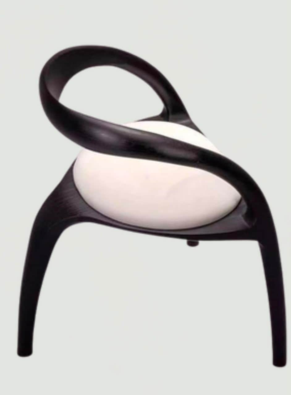 A modern accent chair featuring a dark, sculptural wooden frame with an integrated, looping backrest… — 3D model
