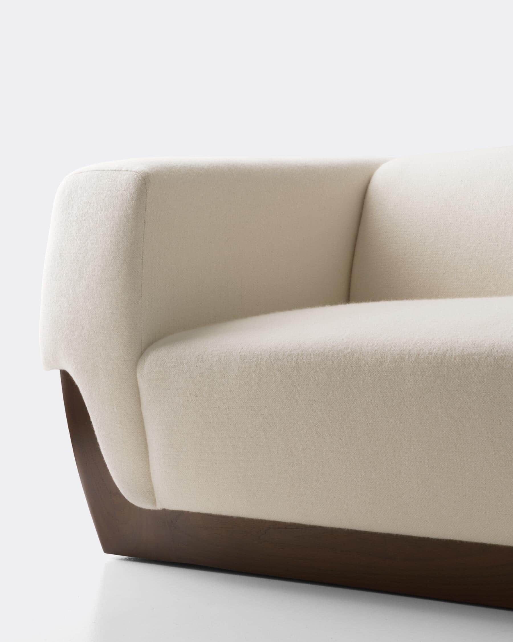 A close-up view of a segment of a modern sofa. The upholstery appears to be a textured fabric in an… — 3D model