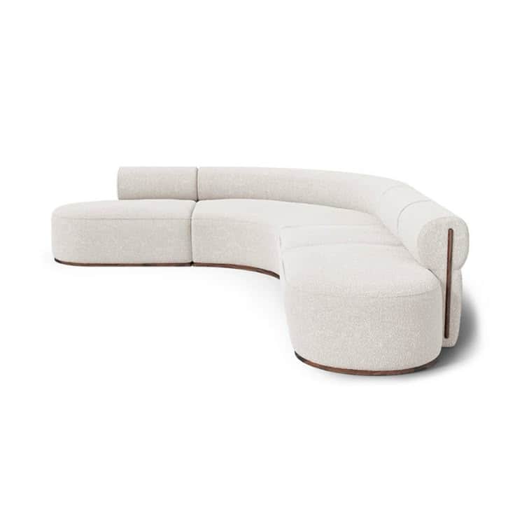 A contemporary, off-white, curved sectional sofa featuring soft boucle upholstery and a dark wooden… — 3D model