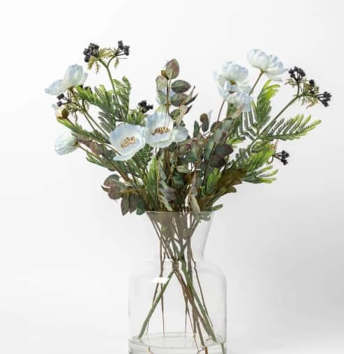 A decorative arrangement featuring a bouquet of white artificial poppy-like flowers, green fern-like… — 3D model