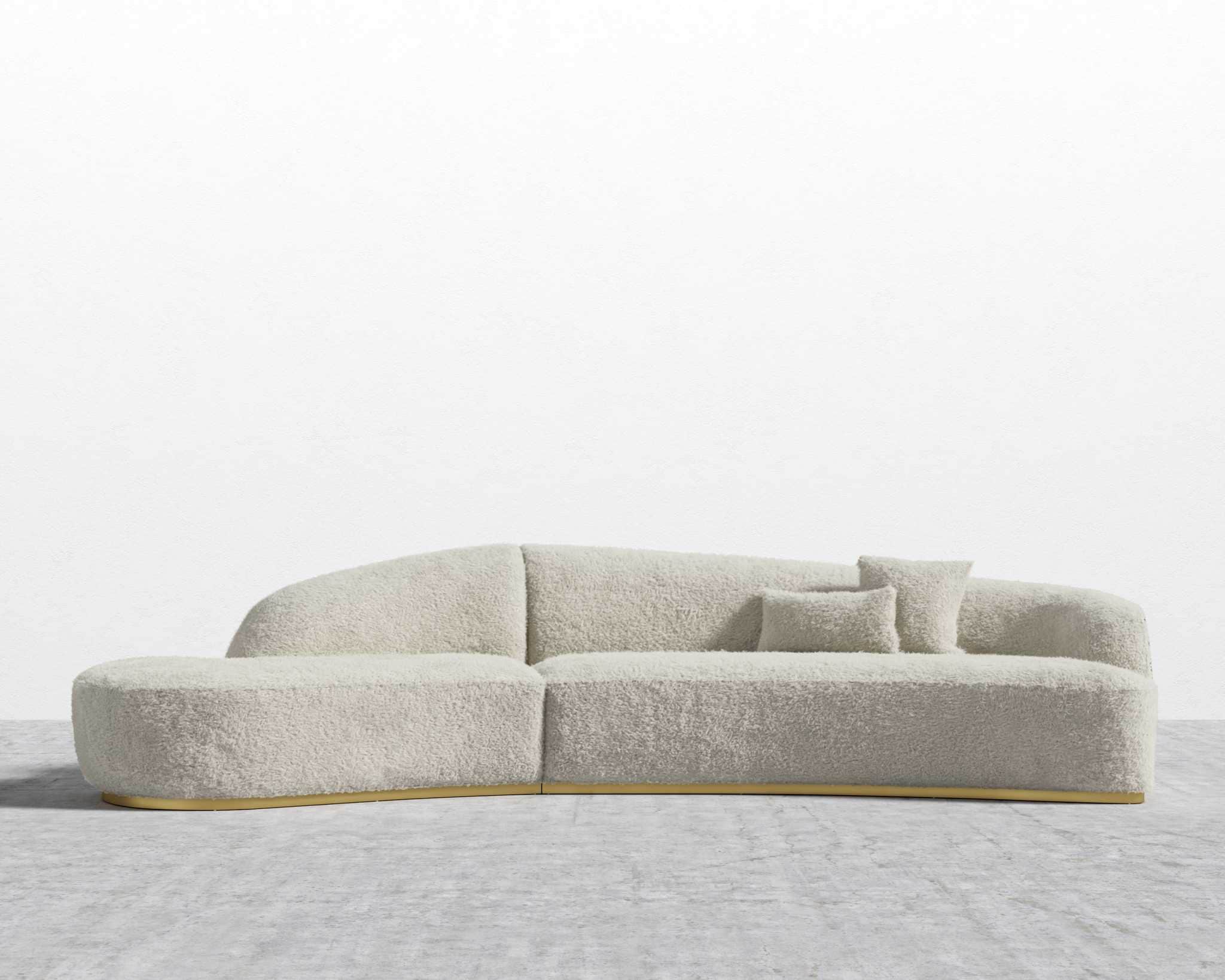 A contemporary modular sectional sofa featuring an asymmetrical, curved design. It is upholstered in… — 3D model