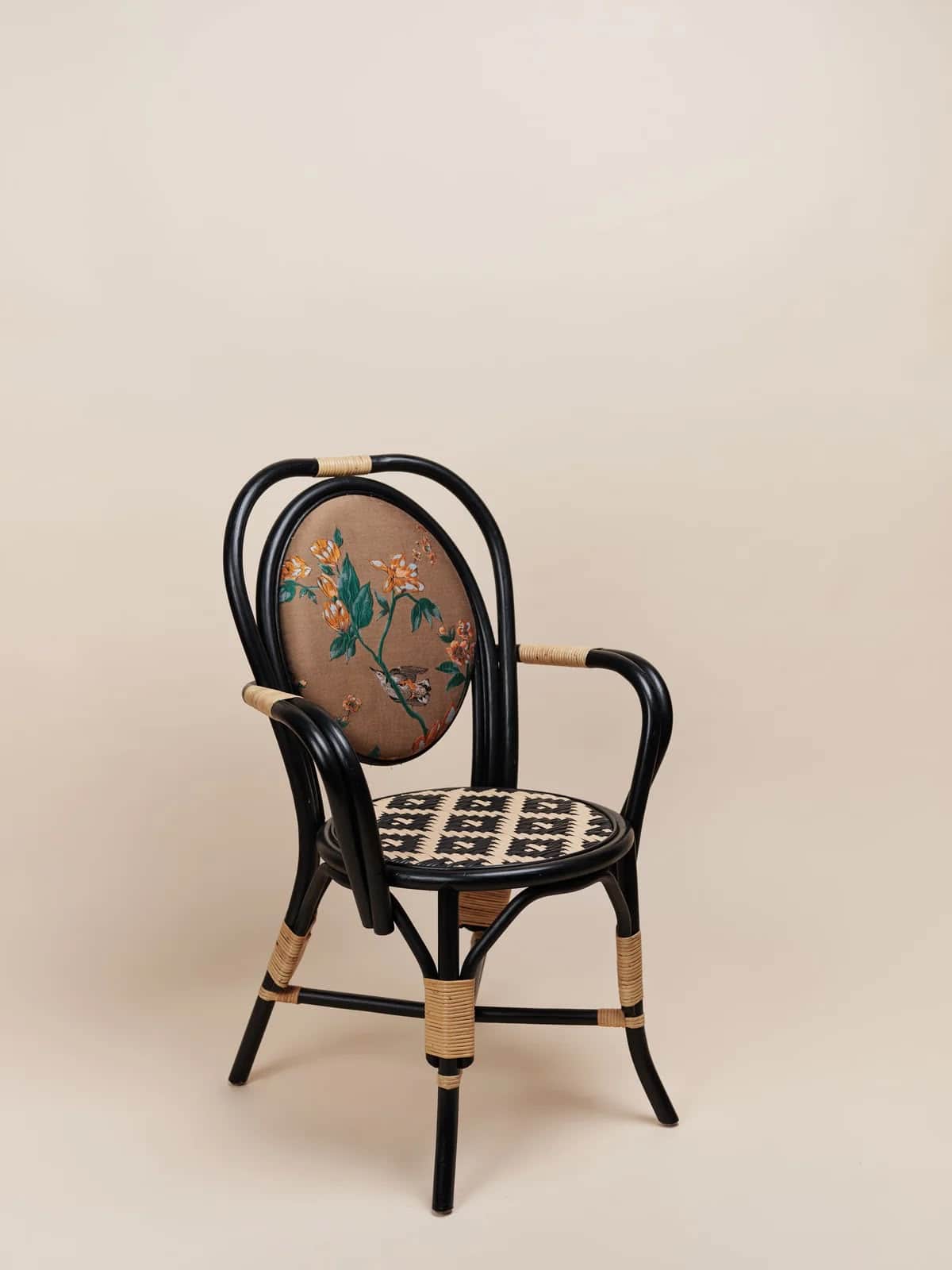 An armchair featuring a black painted rattan or bentwood frame, an oval upholstered backrest with a… — 3D model