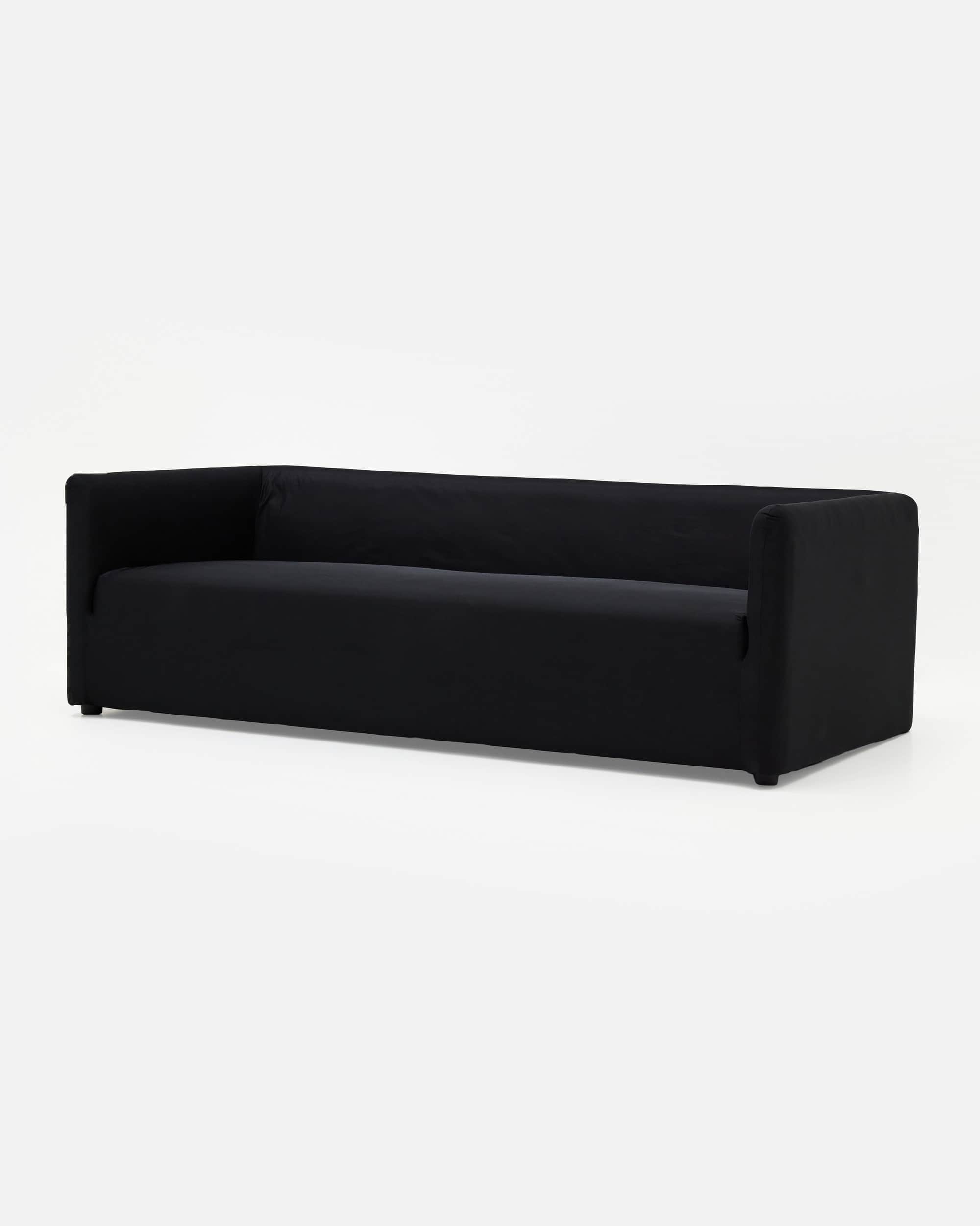 A contemporary three-seater sofa upholstered in plain black fabric, featuring a minimalist design wi… — 3D model