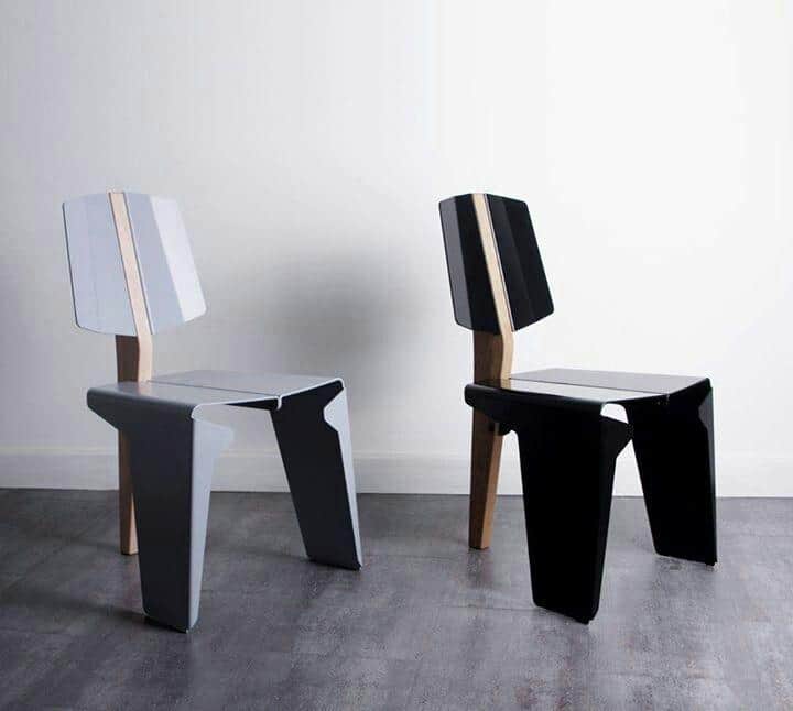 A contemporary armless side chair featuring a distinctive two-tone design, composed primarily of ang… — 3D model