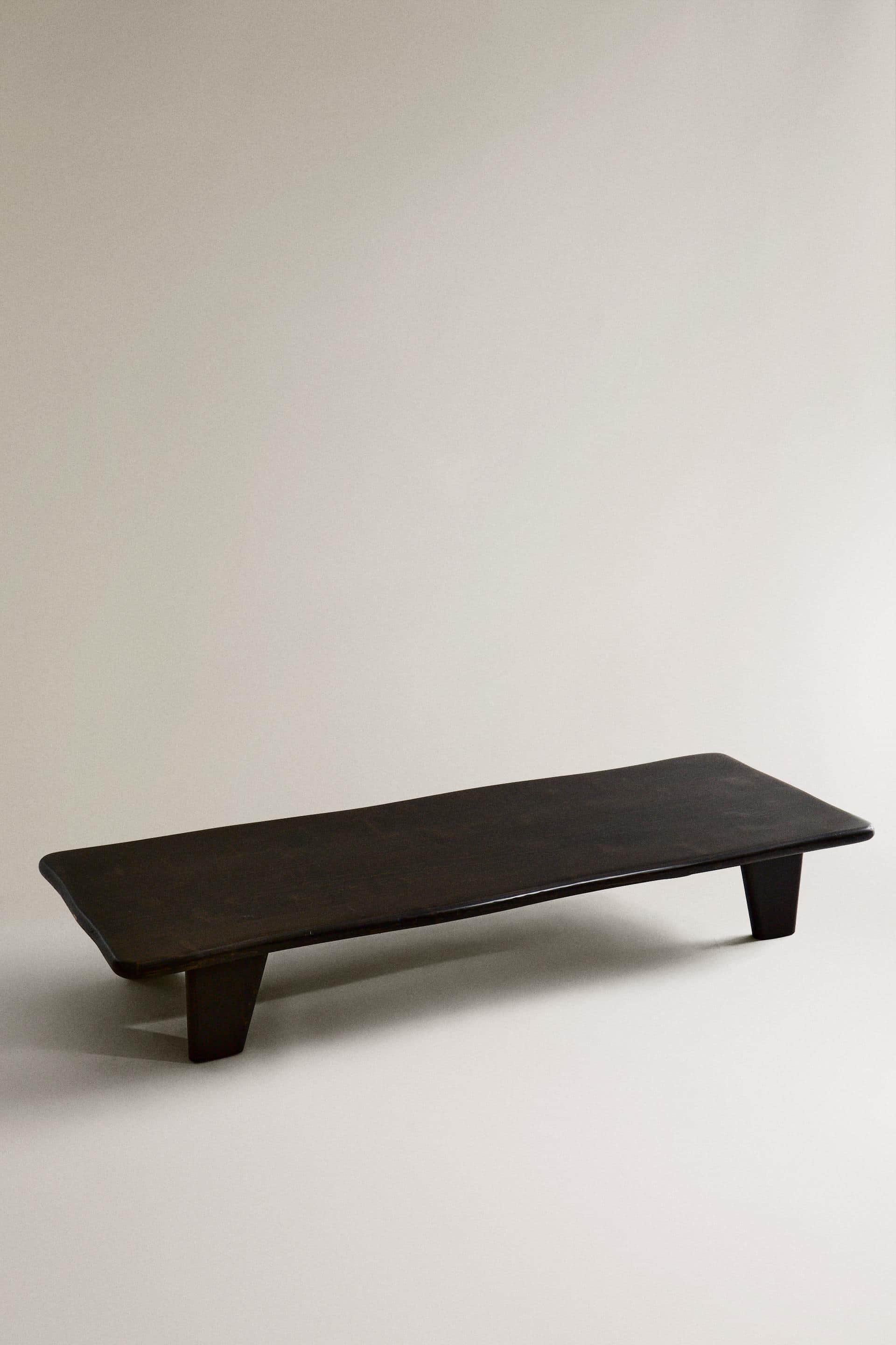 A minimalist, rectangular display riser or monitor stand, crafted from dark brown wood with a smooth… — 3D model