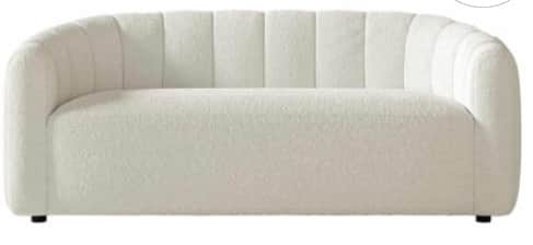 A contemporary, subtly curved sofa upholstered in a cream bouclé fabric, featuring vertical channel… — free GLTF 3D model
