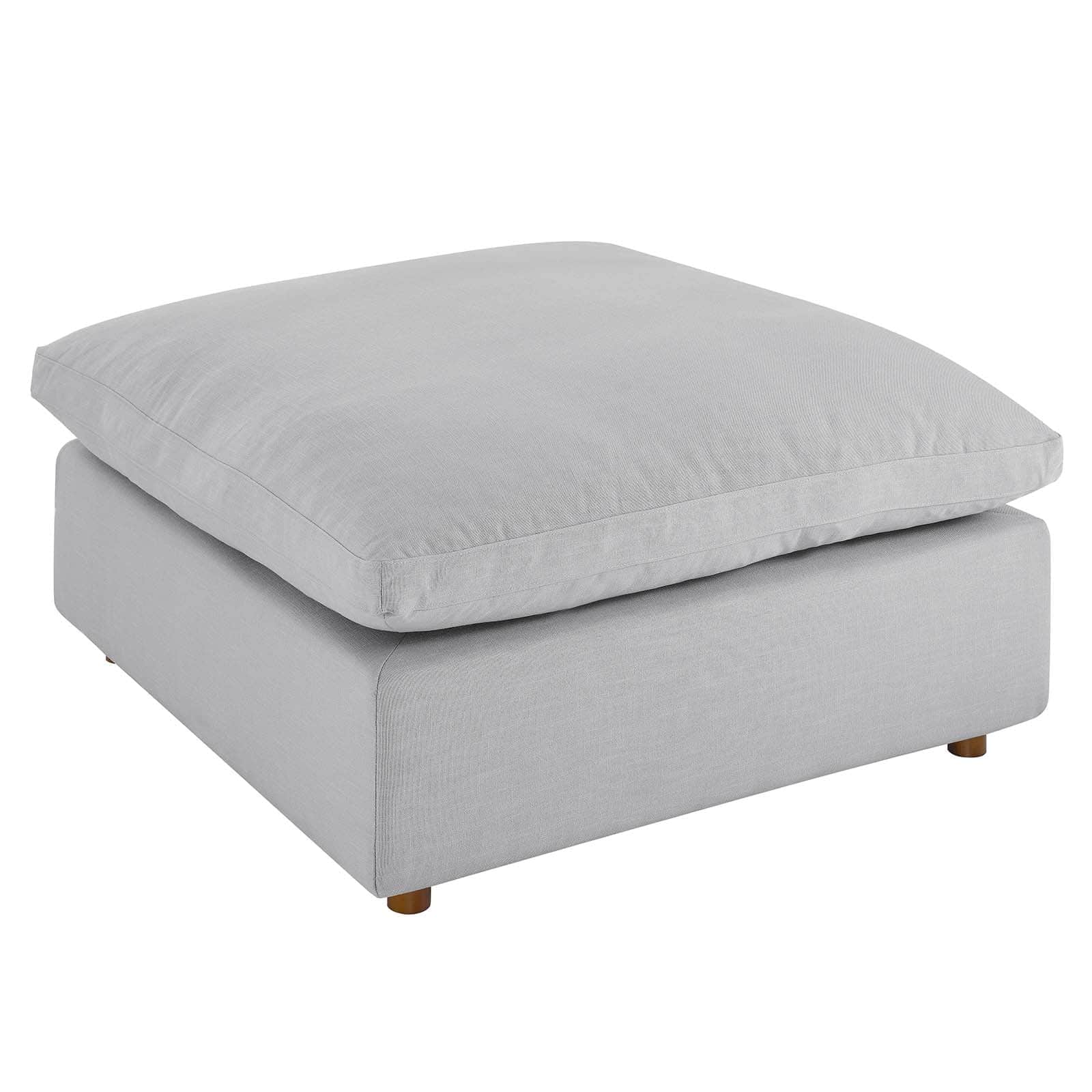 A modern, square-shaped ottoman featuring a light gray, linen-look fabric upholstery. It consists of… — 3D model