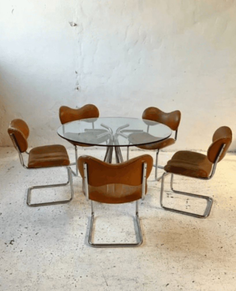A vintage Mid-Century Modern dining set featuring a round glass-top table with a chrome pedestal bas… — 3D model