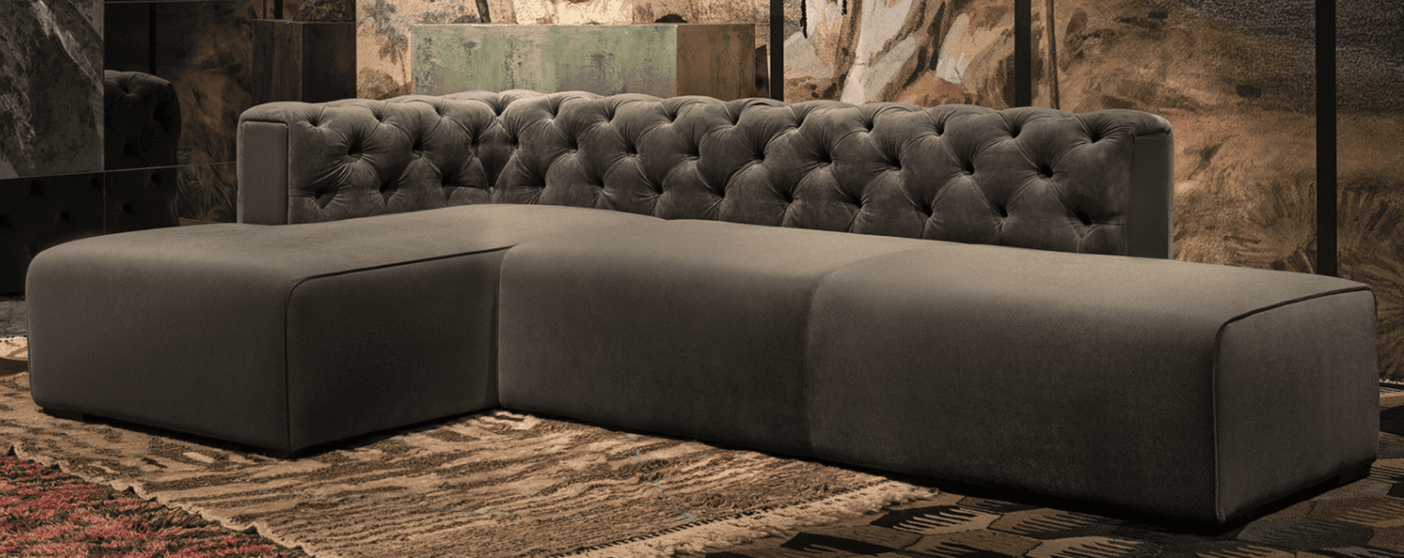 A modular sectional sofa with a tufted backrest on one section and plain upholstered seating modules… — free GLTF 3D model