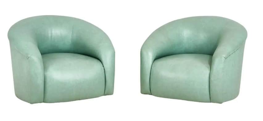 A compact, fully upholstered club chair featuring a barrel-shaped back and integrated armrests. The… — 3D model