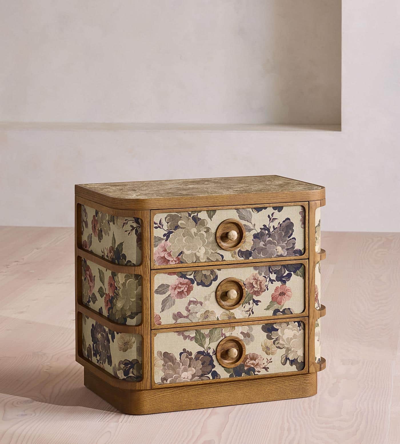 A three-drawer chest of drawers with a wooden frame and a marble or stone-effect top. The drawer fro… — 3D model