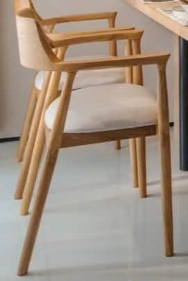 A modern armchair crafted from light-toned wood with a curved backrest and integrated armrests, feat… — 3D model