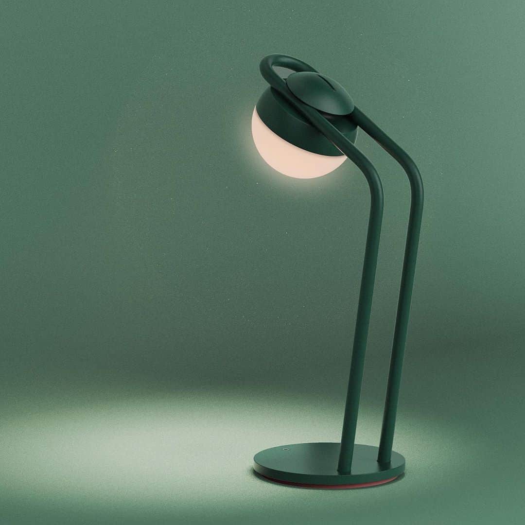 A contemporary table lamp featuring a dark green finish, a spherical light diffuser, and a minimalis… — 3D model