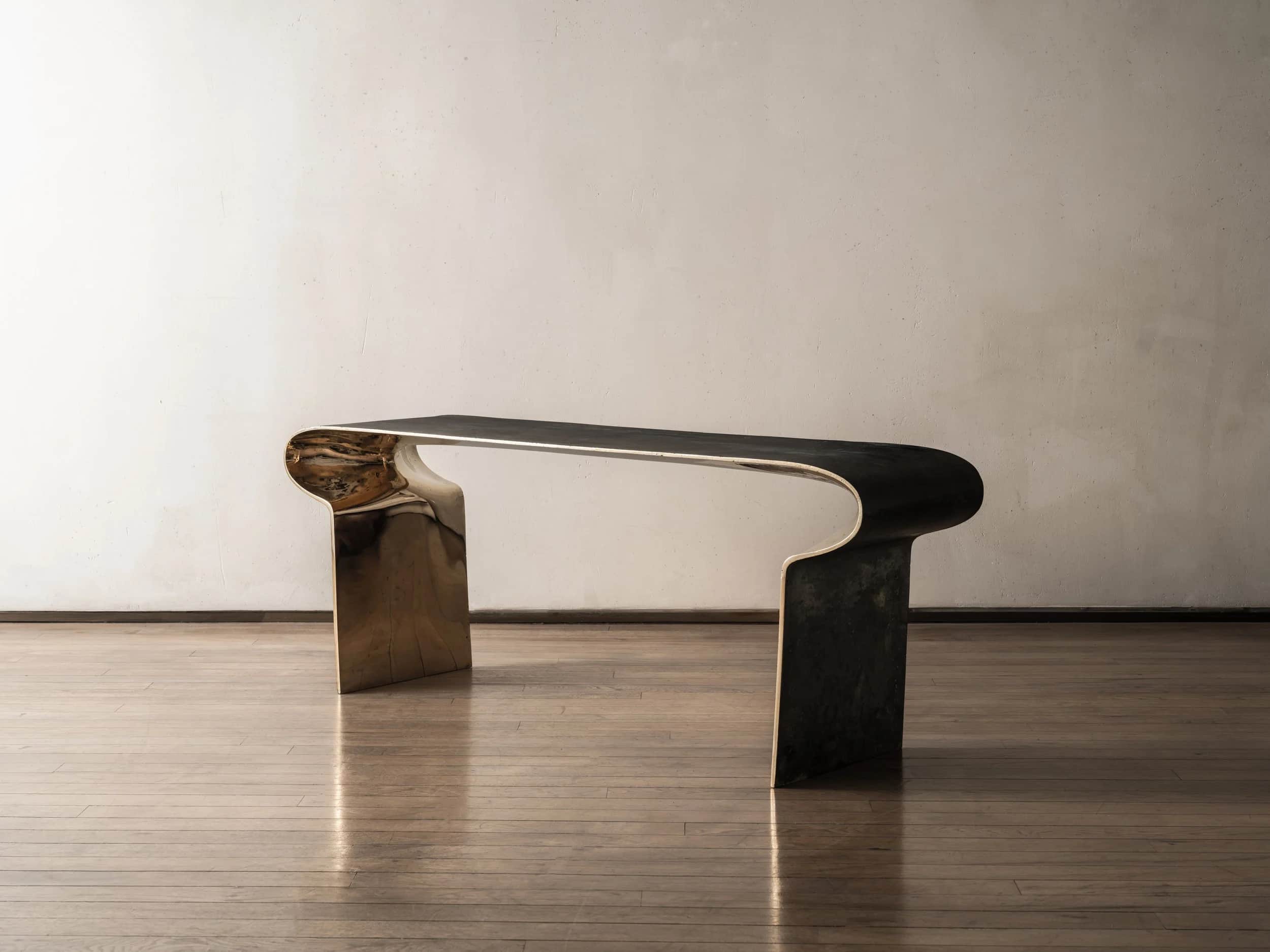 A modern sculptural console table featuring a distinctive two-tone finish. The table is formed from… — 3D model