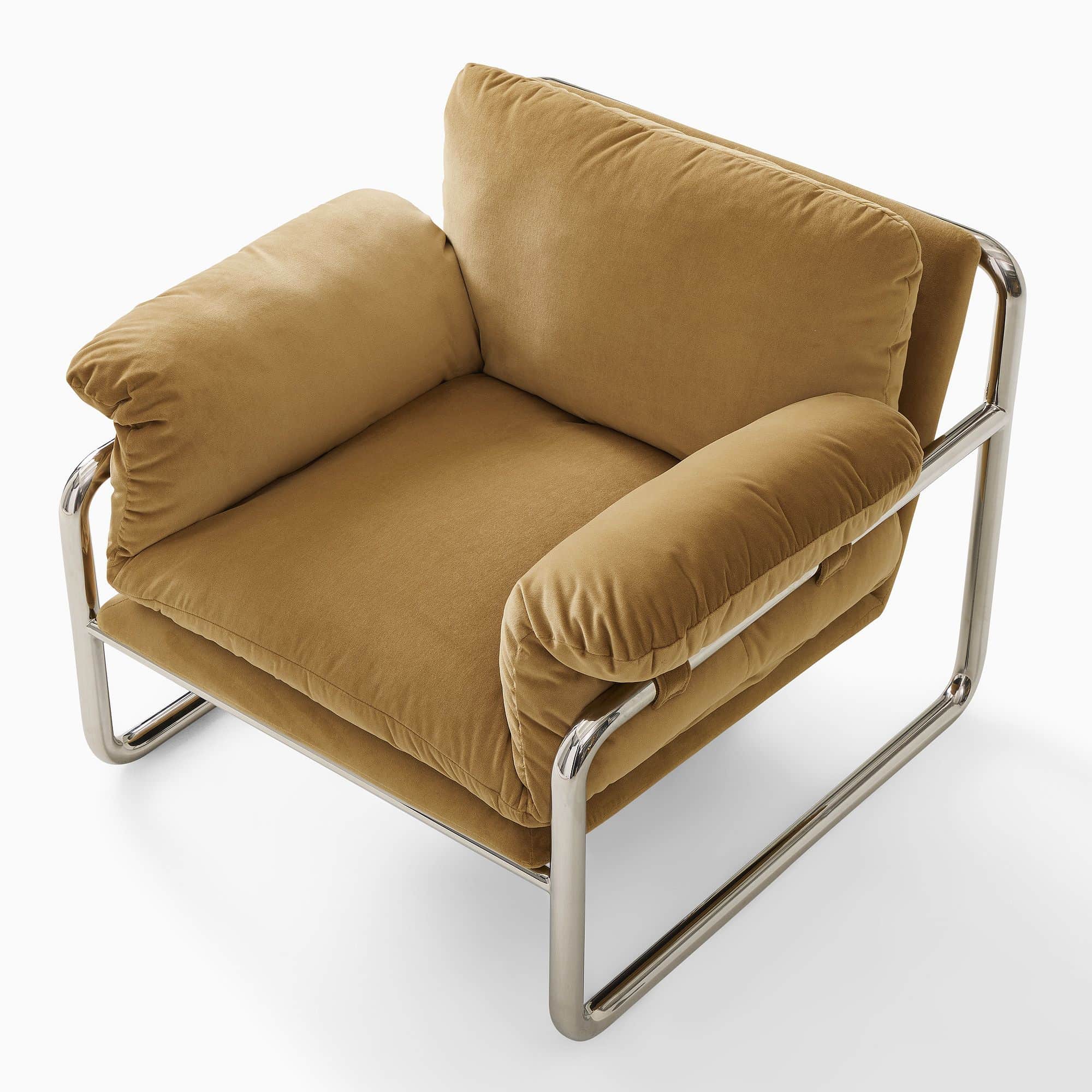 A modern armchair with a tubular chrome frame and plush, upholstered cushions in a camel or mustard… — free GLTF 3D model