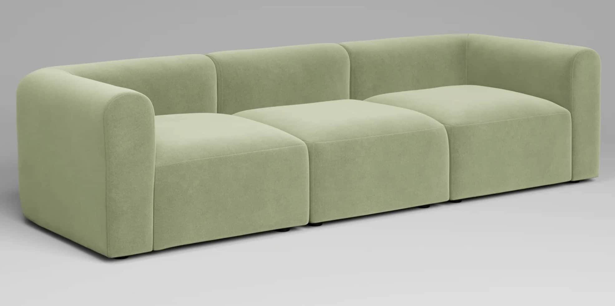 A contemporary three-seater modular sofa upholstered in a light green fabric. The design features a… — 3D model