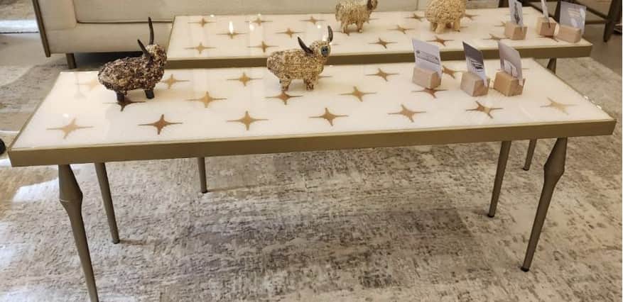 A rectangular console table with a white top featuring a repeating pattern of gold starbursts. The t… — 3D model