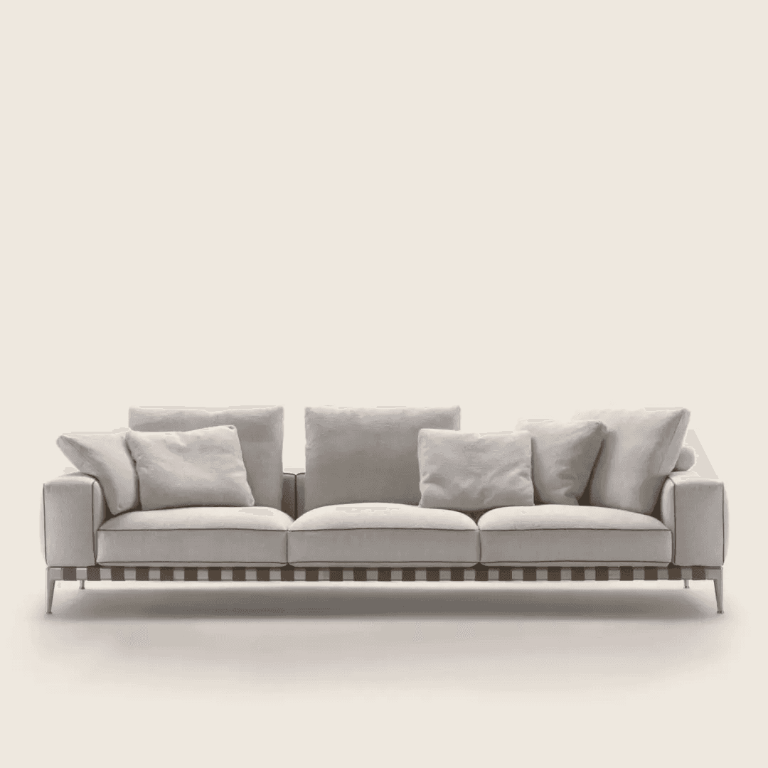 A modern three-seater sofa featuring light-colored fabric upholstery, loose back and seat cushions,… — 3D model