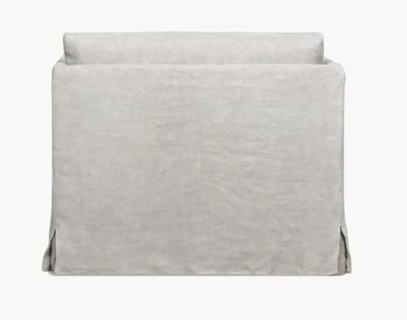 A light grey or off-white slipcovered sofa, viewed from the back, featuring a full skirted base with… — free GLTF 3D model