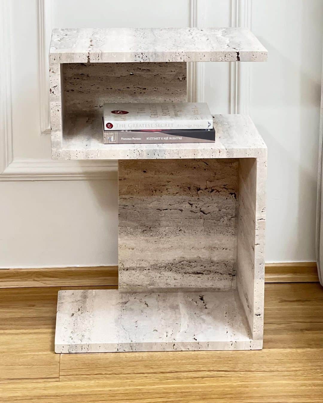A C-shaped end table constructed from travertine stone, featuring an offset stacking design. The tab… — 3D model