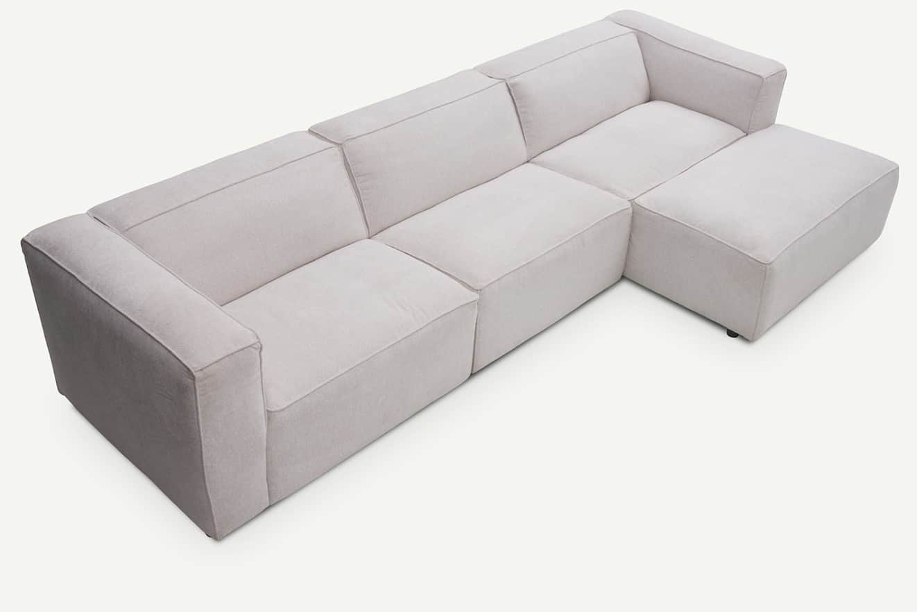 A light beige modular L-shaped sectional sofa with a chaise lounge. The sofa features clean lines, b… — 3D model