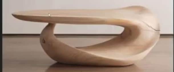 A low, sculptural coffee table characterized by its fluid, biomorphic shape crafted entirely from li… — 3D model