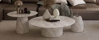 A contemporary coffee table featuring a round white marble top supported by a substantial cylindrica… — free GLTF 3D model