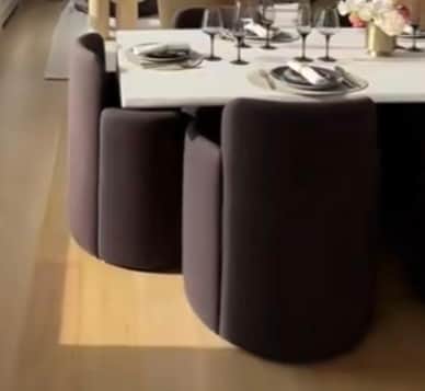 A modern armchair with a curved backrest and integrated armrests. The seat and base are cylindrical,… — free OBJ 3D model