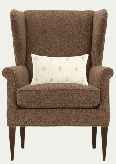 A brown tweed upholstered wingback chair with a lumbar pillow. The chair features a high back with p… — 3D model
