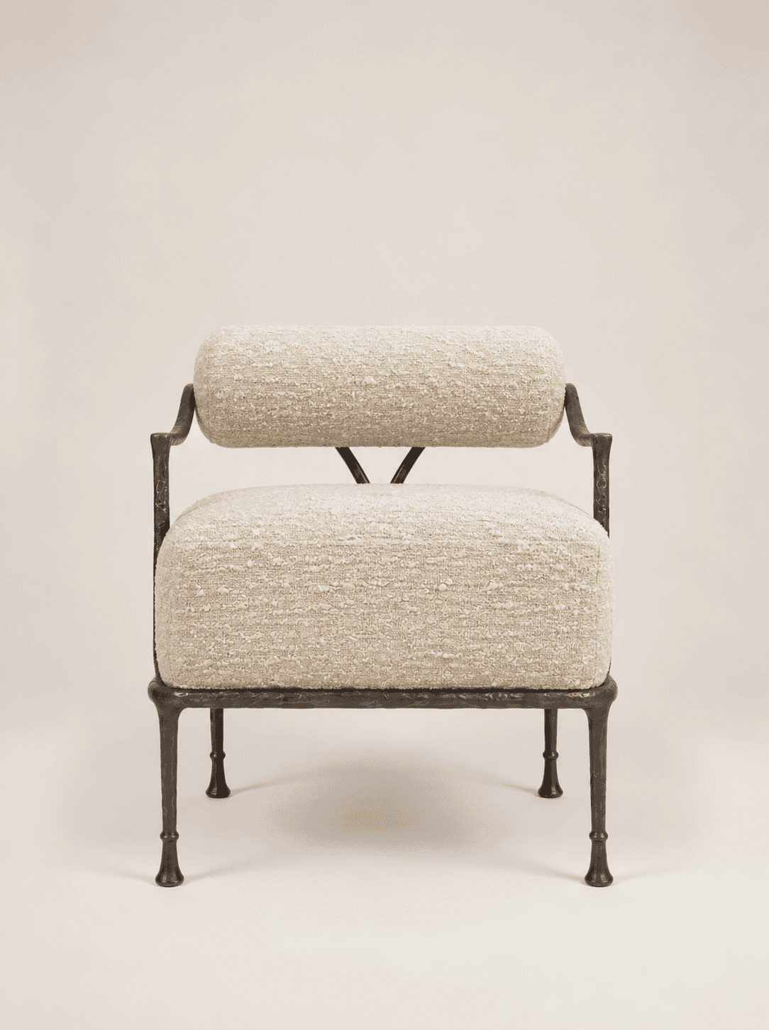 An accent chair featuring a dark, hammered or forged metal frame and upholstered in a light-colored,… — 3D model