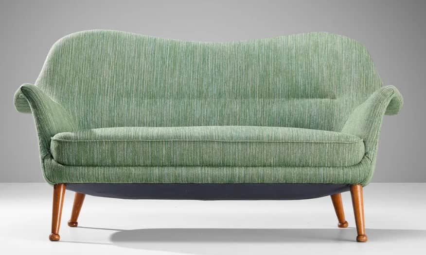 A two-seater sofa with a curvaceous backrest and armrests, upholstered in a textured green fabric. T… — 3D model