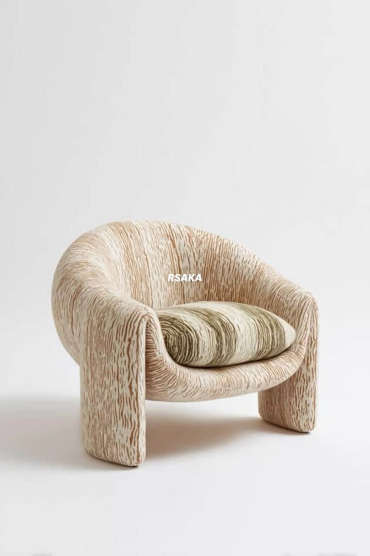 A low-profile armchair with an organic, rounded form, upholstered in a textured fabric resembling wo… — 3D model