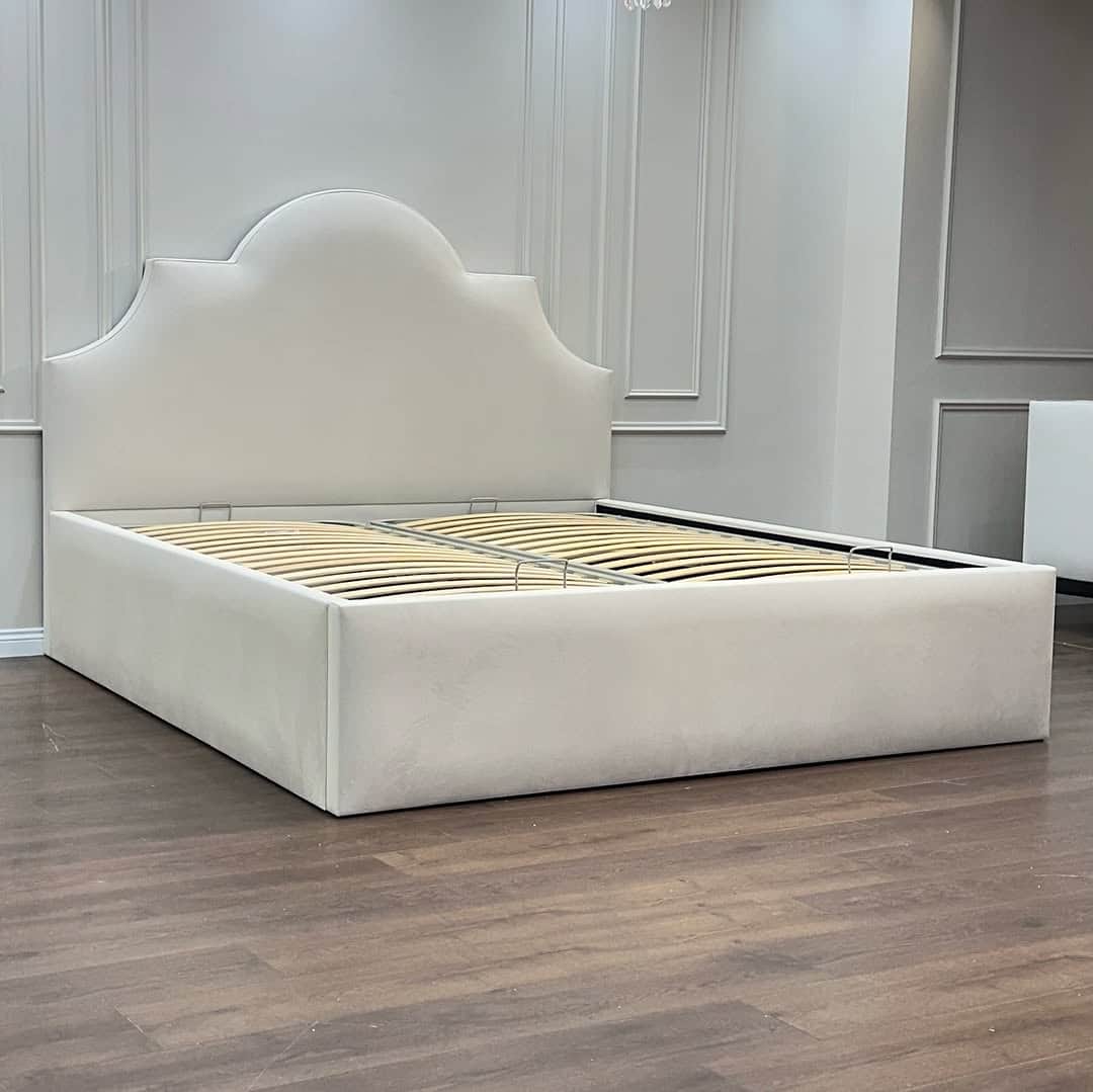 A contemporary upholstered platform bed frame featuring a distinctive scalloped headboard and a robu… — 3D model