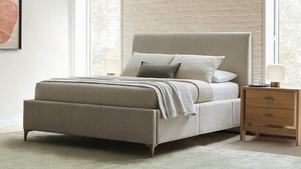 A contemporary upholstered platform bed featuring a soft, neutral-colored fabric. The bed includes a… — 3D model
