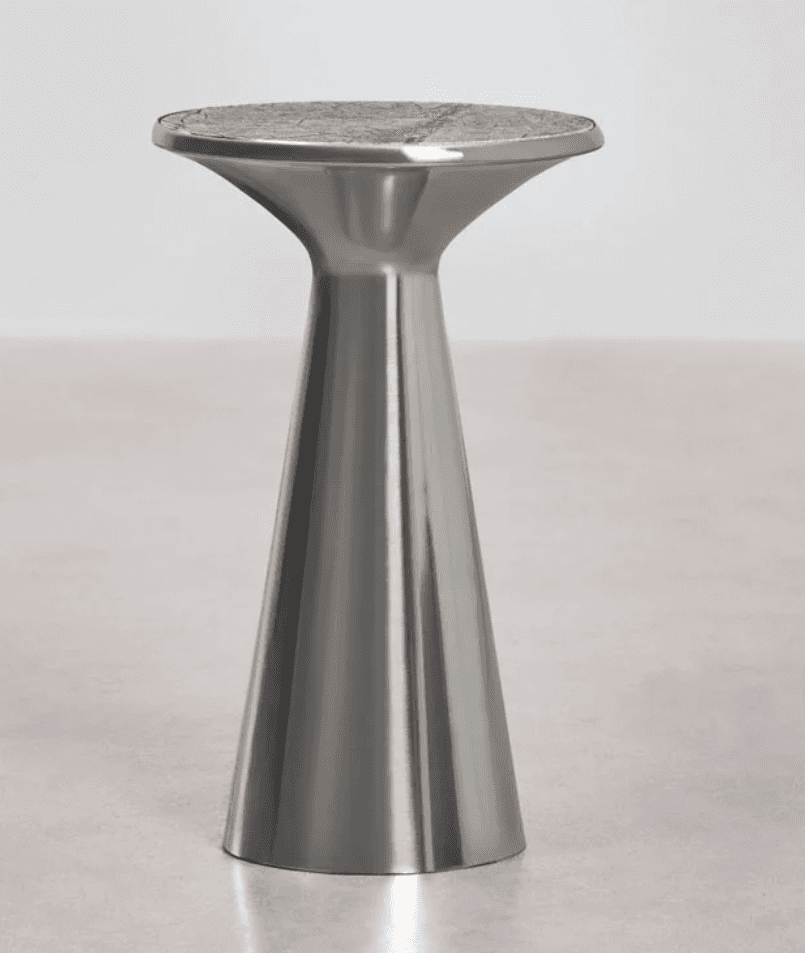 A modern pedestal accent table featuring a brushed metallic finish on its conical base and a round,… — 3D model