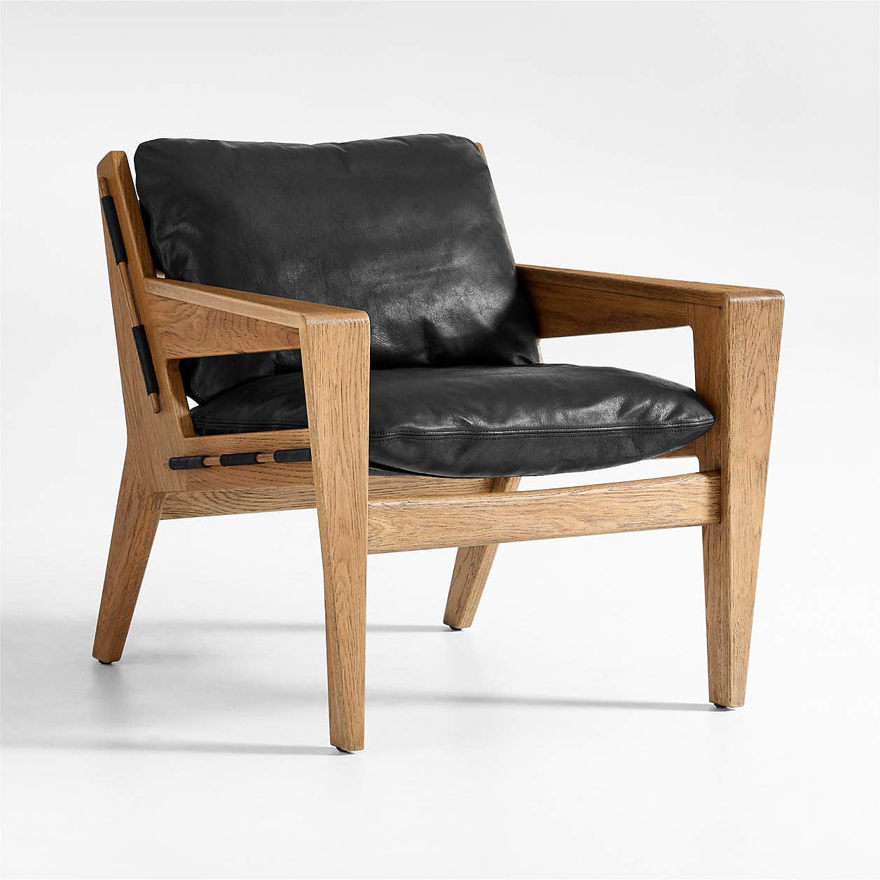 A modern armchair with a solid wood frame and black leather cushions. The frame features a clean, an… — free FBX 3D model