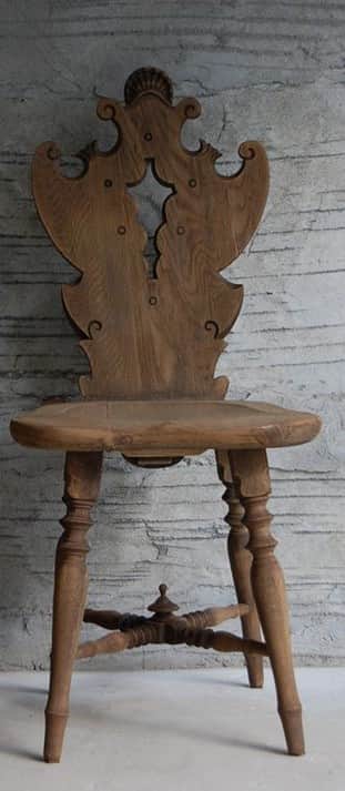 A highly decorative wooden side chair featuring elaborate carving on its backrest, a sculpted seat,… — 3D model