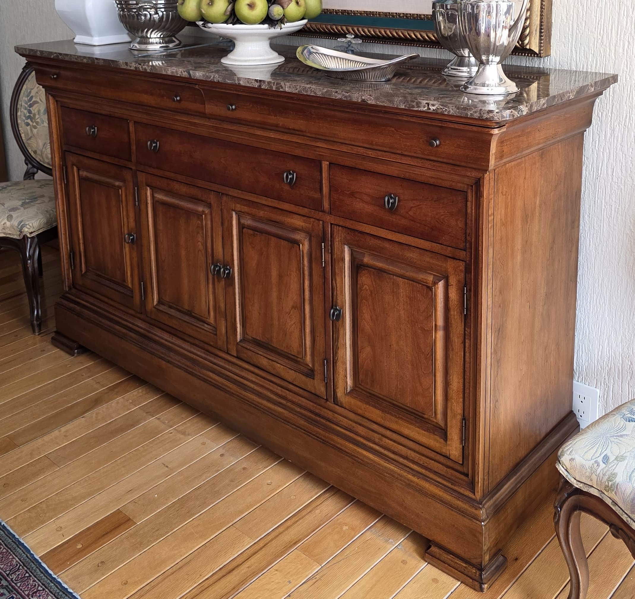 A wooden sideboard with a marble top. It features multiple drawers and cabinet doors with metal hard… — free BLEND 3D model
