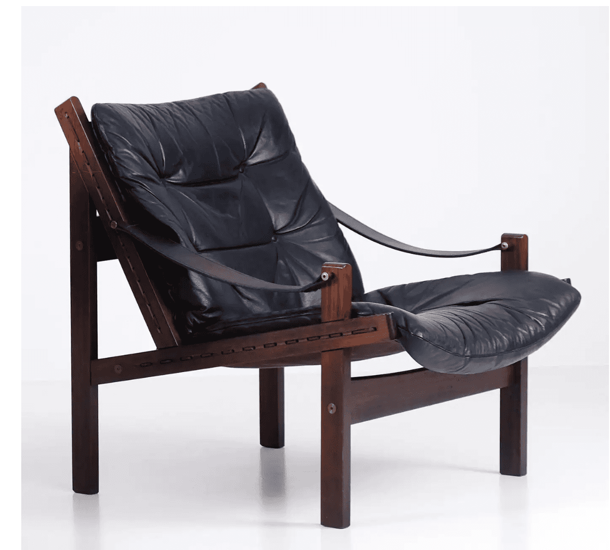A low-slung lounge chair featuring a dark-stained solid wood frame, likely rosewood, with exposed jo… — 3D model