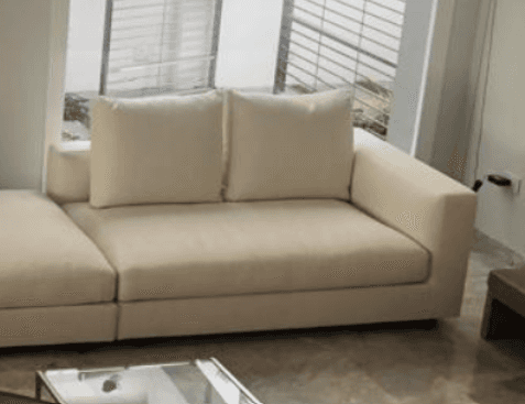 A contemporary modular sectional sofa featuring light-colored fabric upholstery, comprising a main s… — 3D model