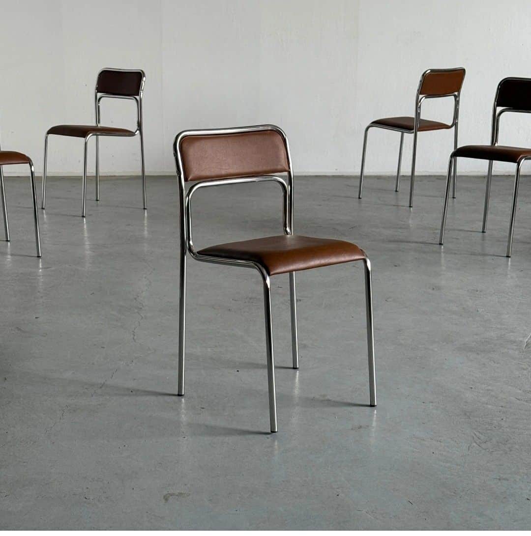 A modern chair with a tubular chrome-plated metal frame and brown upholstered seat and backrest. The… — 3D model